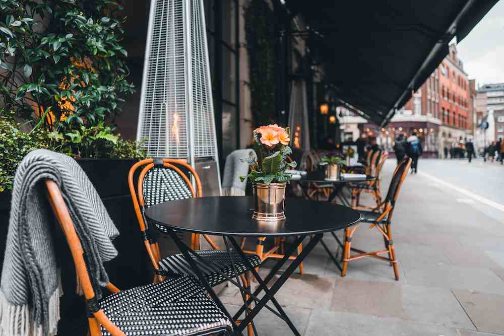 Empty tables outside restaurant in London, UK